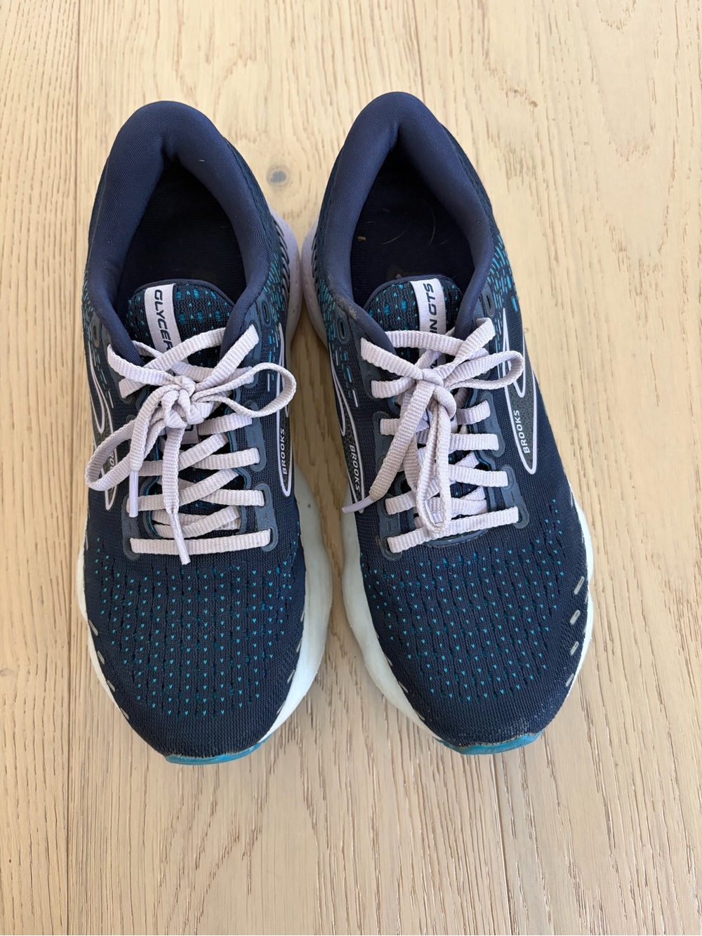 Brooks navy running shoes with teal accents and light pink logo